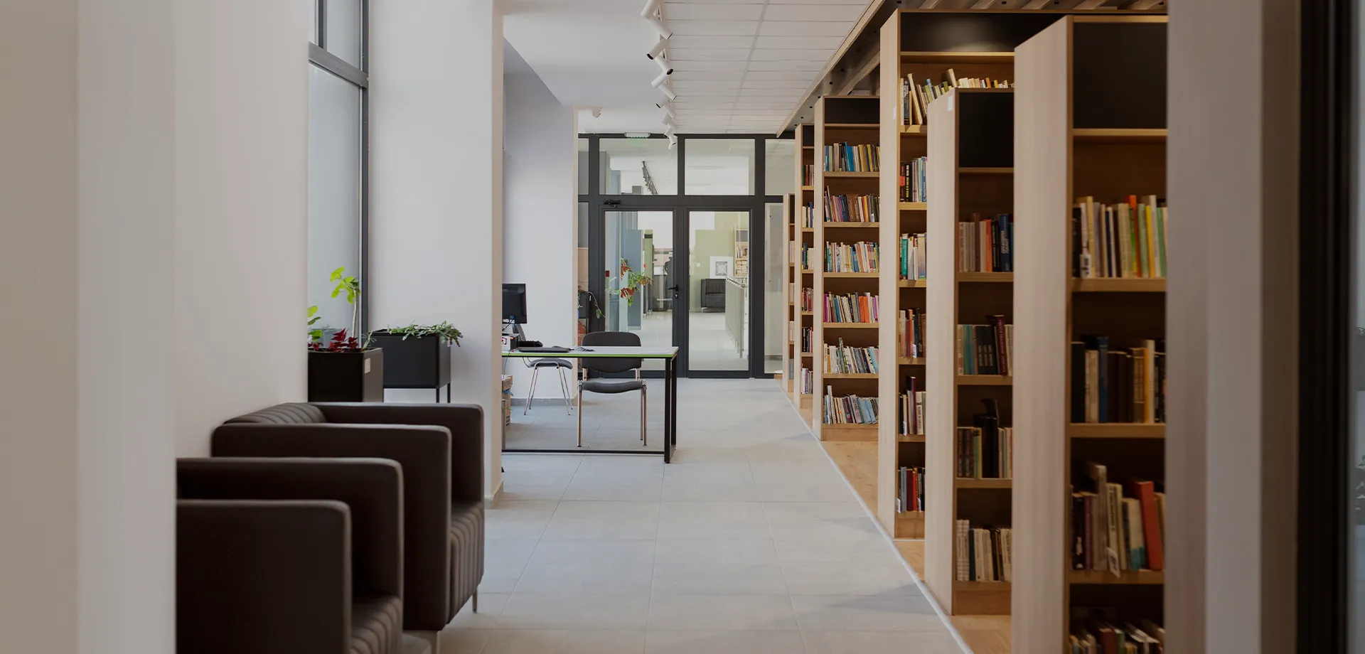 Library with bookshelves and reading seating at Club N'Spire